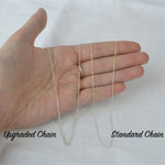 Two necklace chains on a hand